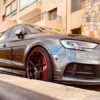 Audi with red AlloyGator wheel protection parked against a curb
