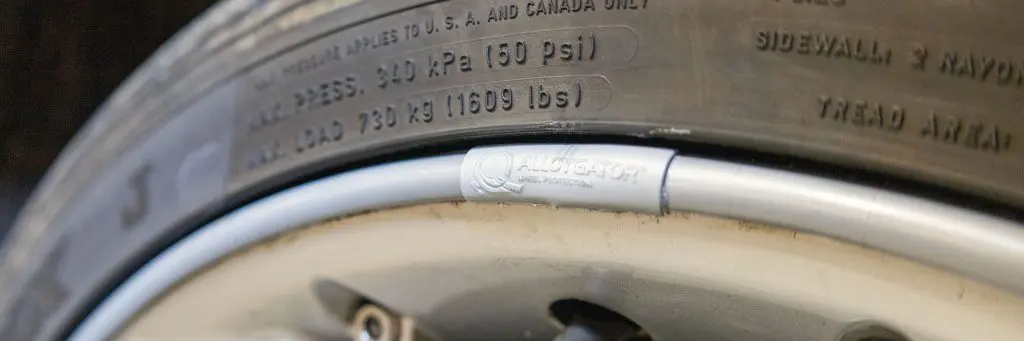 An AlloyGator alloy wheel protector on the rim.