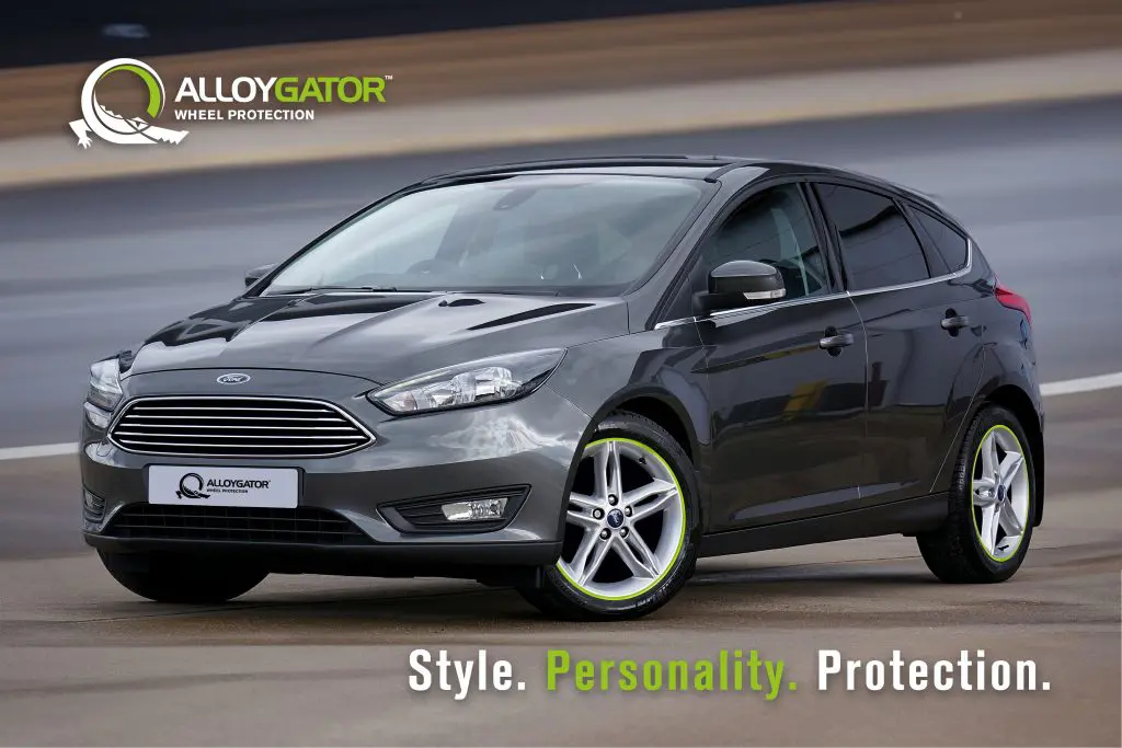 Graphite Ford featuring vibrant green AlloyGators, highlighting a unique contrast that adds personality and ensures wheel protection.