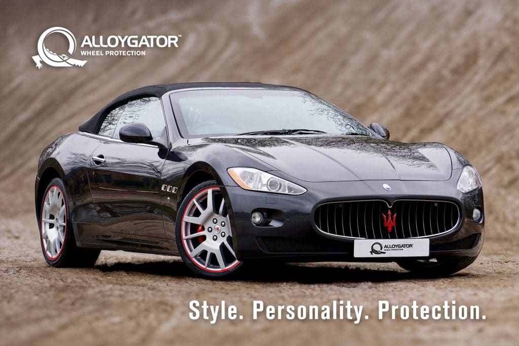 Black Maserati equipped with striking red AlloyGators, showcasing a blend of luxury and bold style under the tagline: Style. Personality. Protection.