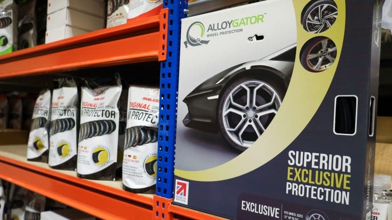 AlloyGator and Rimblades alloy wheel protectors displayed together on a retail shelf.
